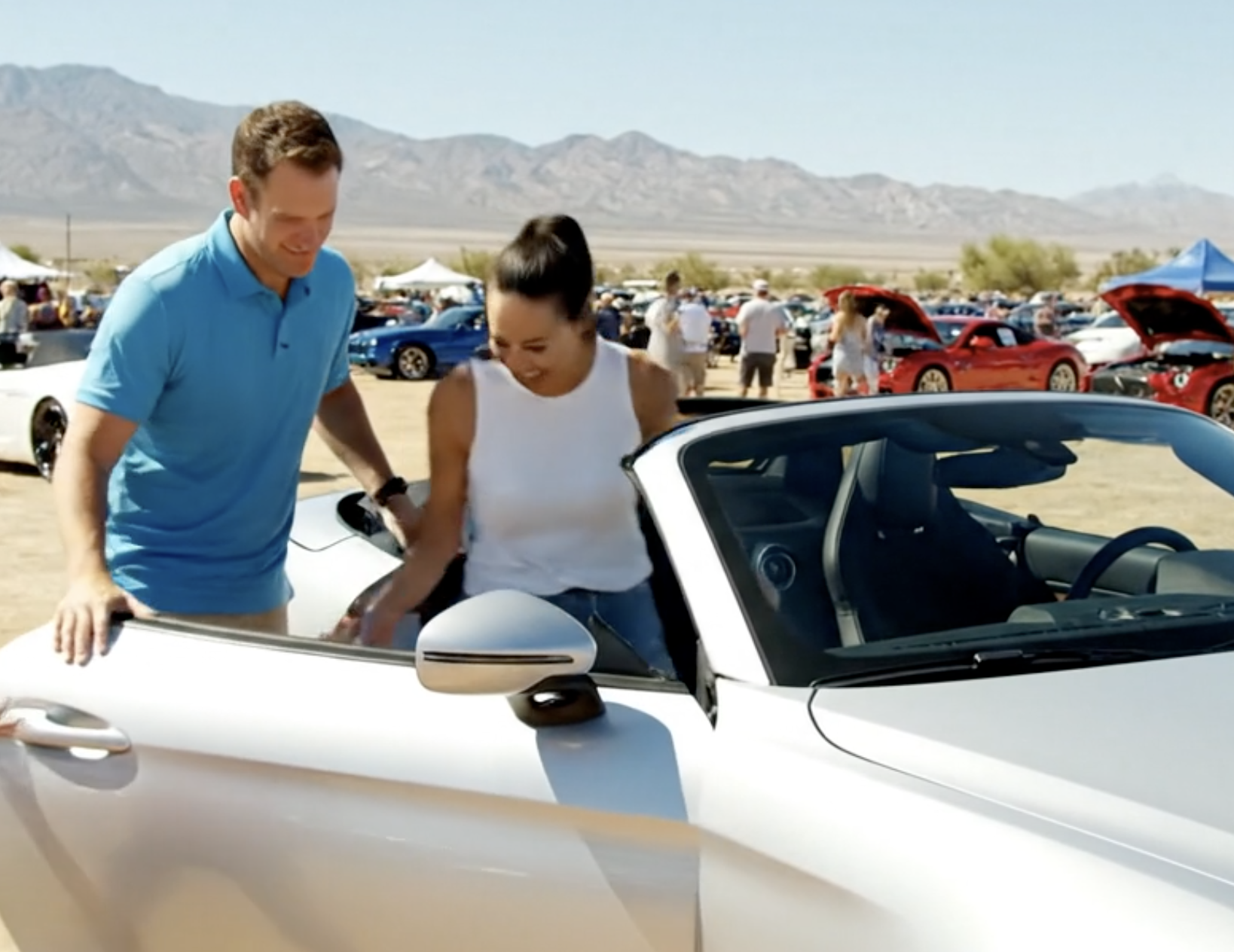 Buyers previewing a vehicle before an Arizona auto auction